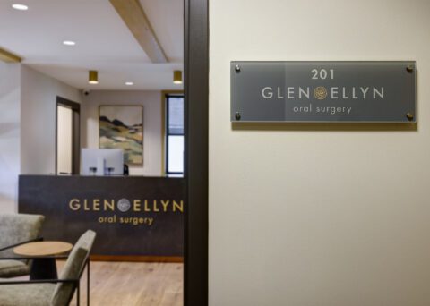 Glen Ellyn Implant & Oral Surgery reception area designed and built by RWE Design Build with a stone feature wall and fireplace